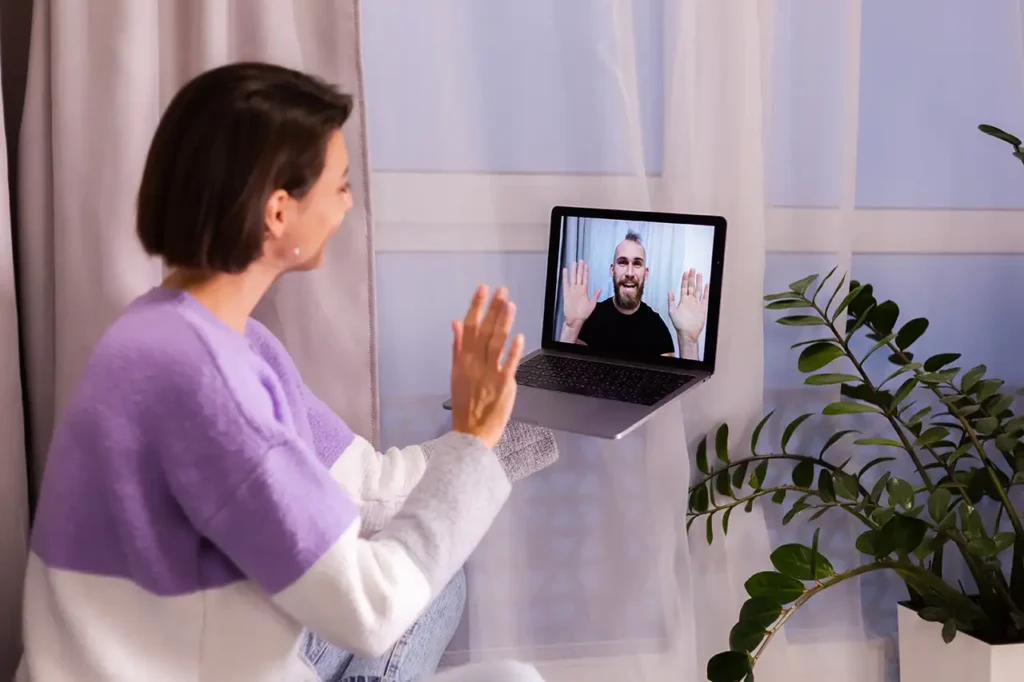 woman at home face time video call with therapist