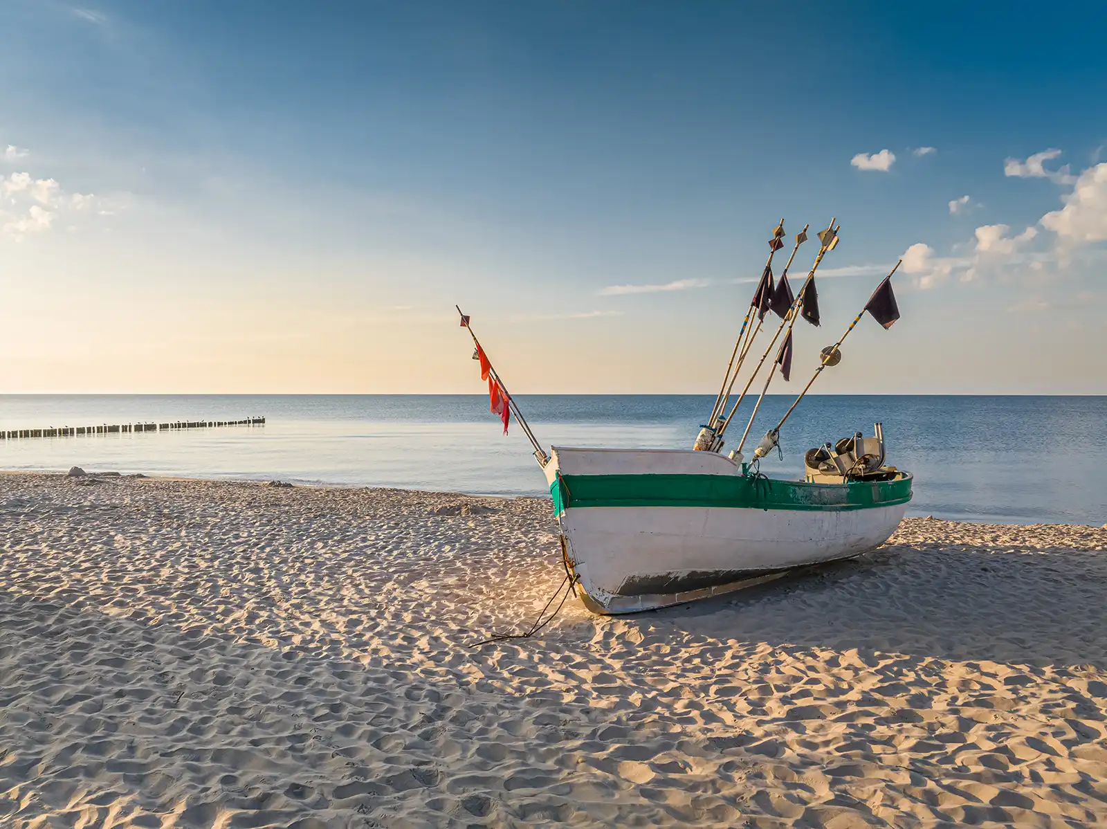 fishing boat by the baltic sea in summer at sunrise